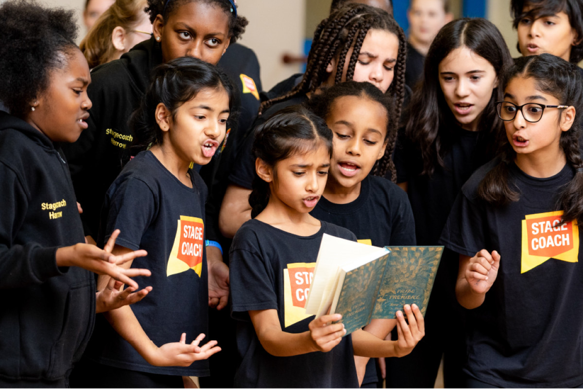 Stagecoach student developing singing, dancing and acting skills in a performing arts class.