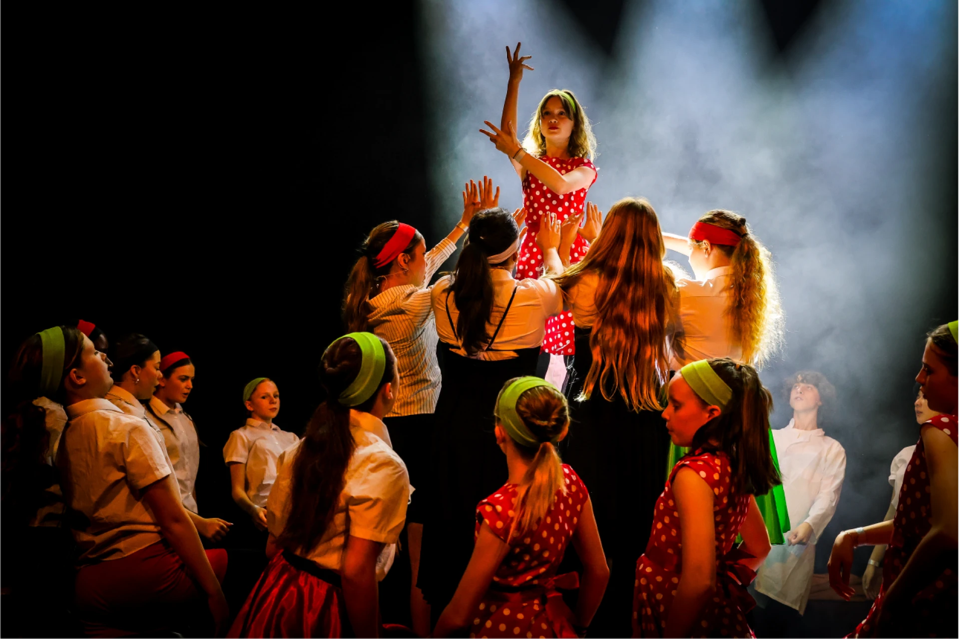 Stagecoach students performing together on stage during a summer camp show.