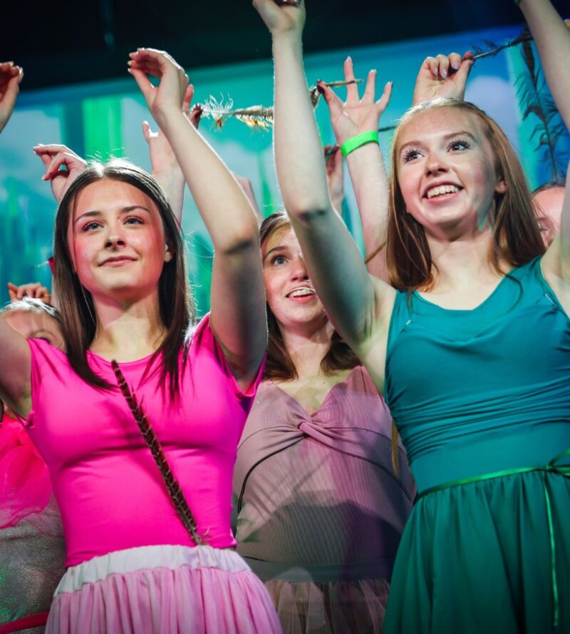 Stagecoach students performing on stage during a children’s performing arts class.