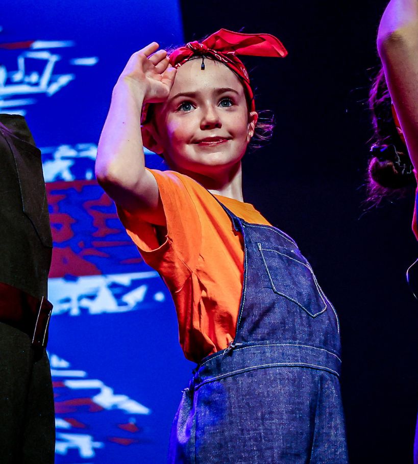 Young Stagecoach student performing on stage during a summer camp production.