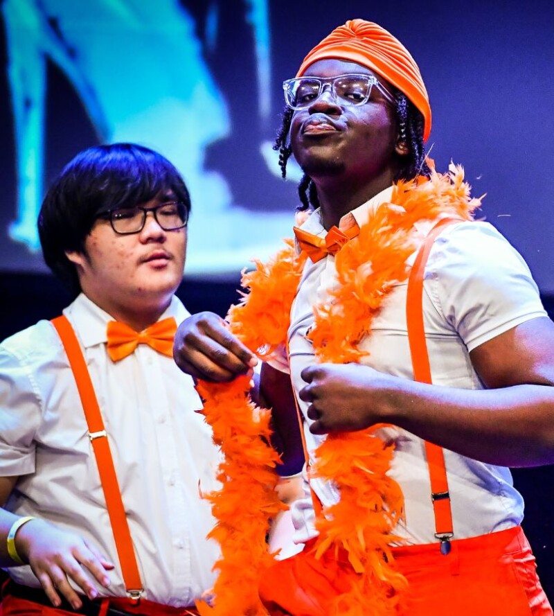 Stagecoach students performing together on stage in costume.