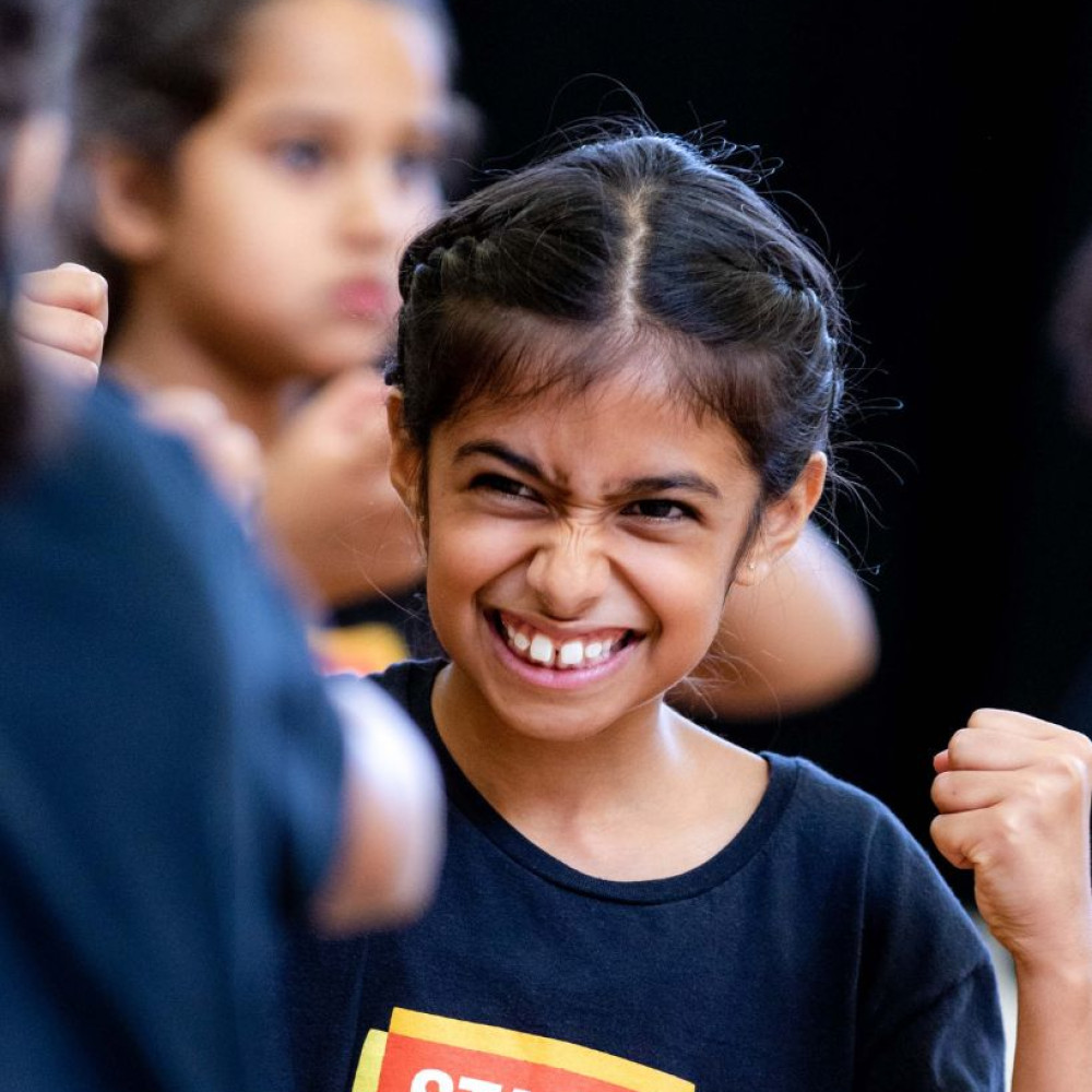 Smiling Stagecoach student in a Stagecoach performing arts class uniform.