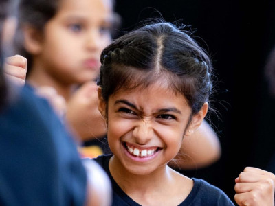 Smiling Stagecoach student in a Stagecoach performing arts class uniform.